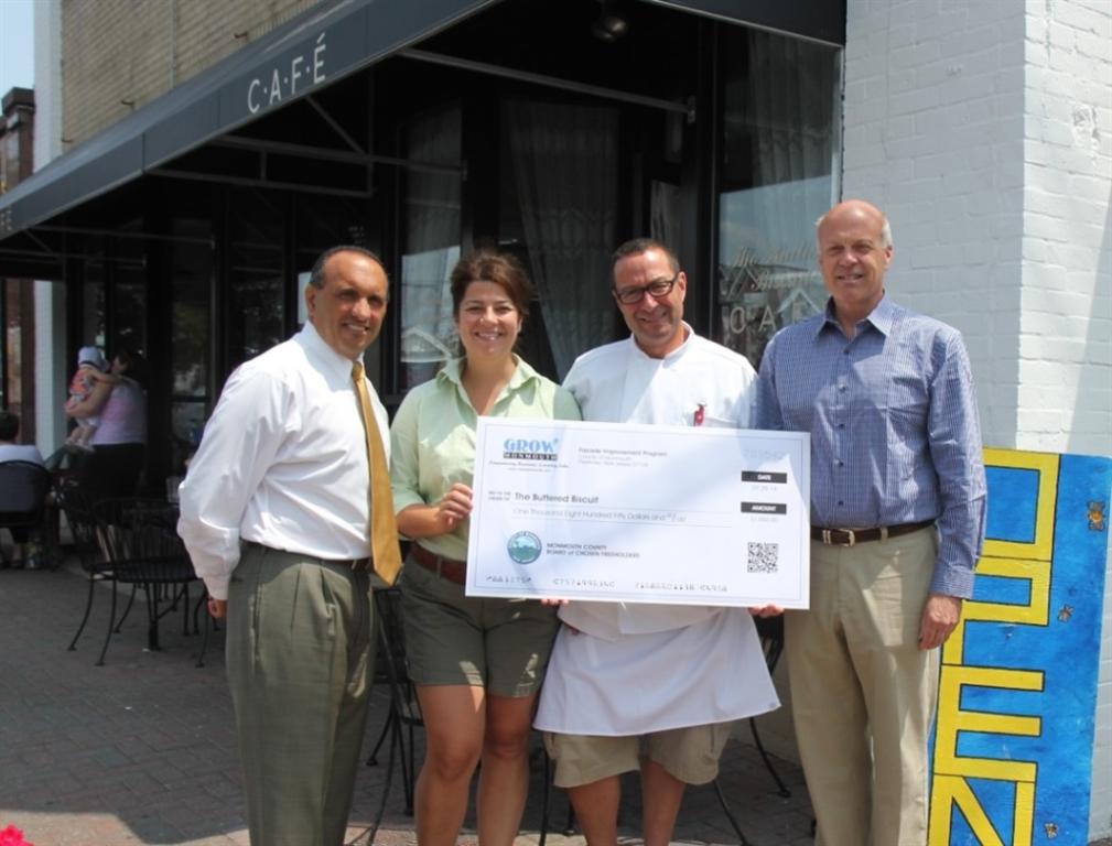 Elizabeth and David McAllister, owners of The Buttered Biscuit, accept a Façade Improvement Program reimbursement check for $1,850 from Freeholder Thomas A. Arnone and Freeholder Deputy Director Gary J. Rich, Sr. on July 29, 2014 in Bradley Beach, NJ.